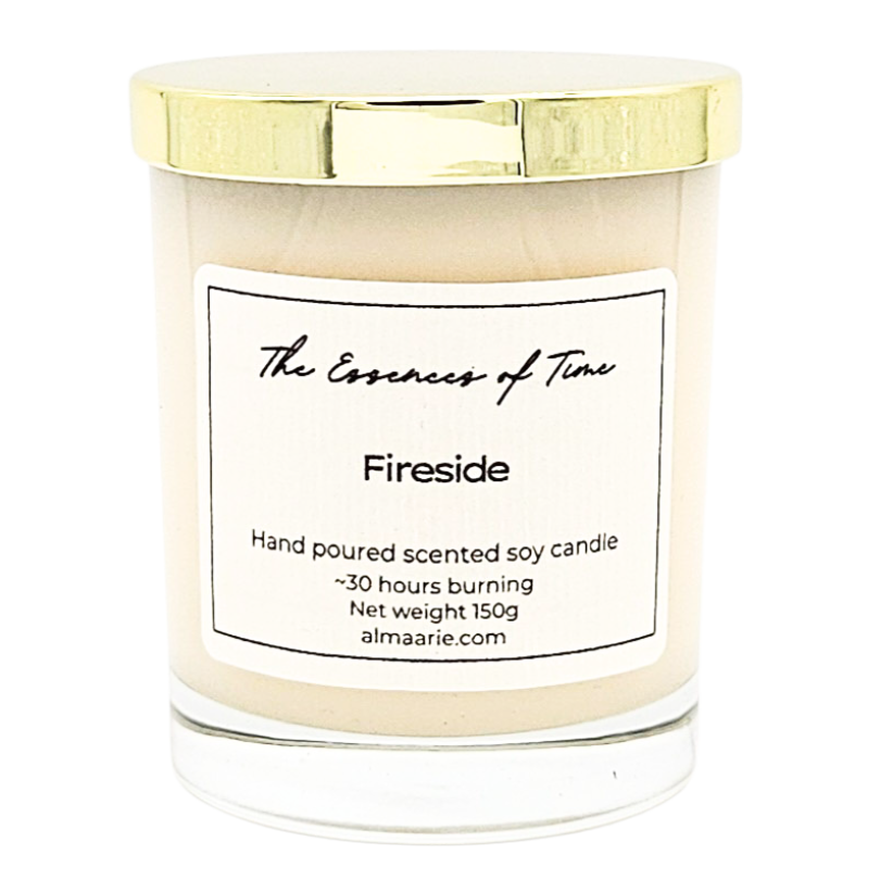 Fireside scented soya candle in an elegant and clear glass vessel with gold lid.