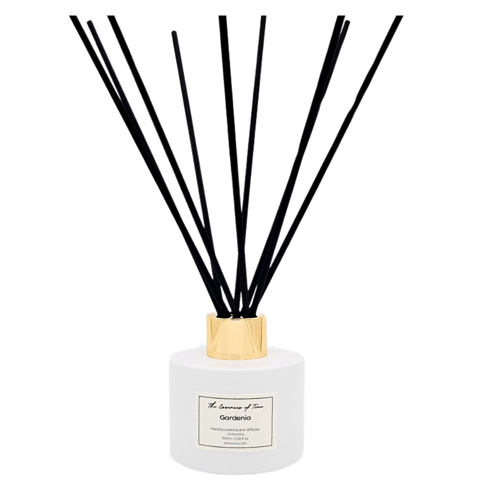 Gardenia scented reed diffuser in white glass jar with black fiber reeds.