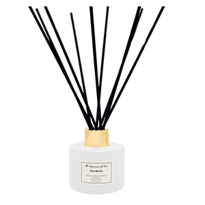 Gardenia scented reed diffuser in white glass jar with black fiber reeds.