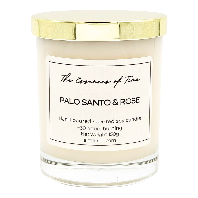 Palo Santo and Rose scented soy candle in a clear lass jar with golden dust cover.