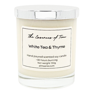 White Tea and Thyme scented candle in clear glass jar with silver lid for gifting.