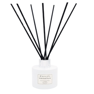 White Tea and Thyme scented diffuser in a white glass jar with black fiber reeds.